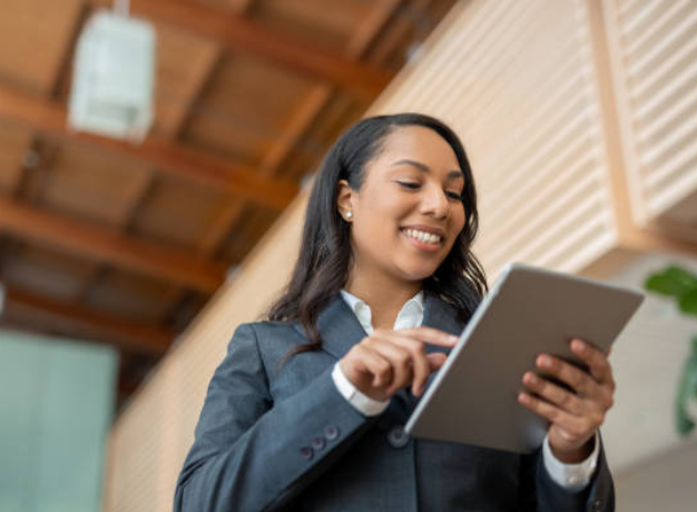 Restaurant manager using a tablet to complete digital food safety, compliance, and workforce management tasks.