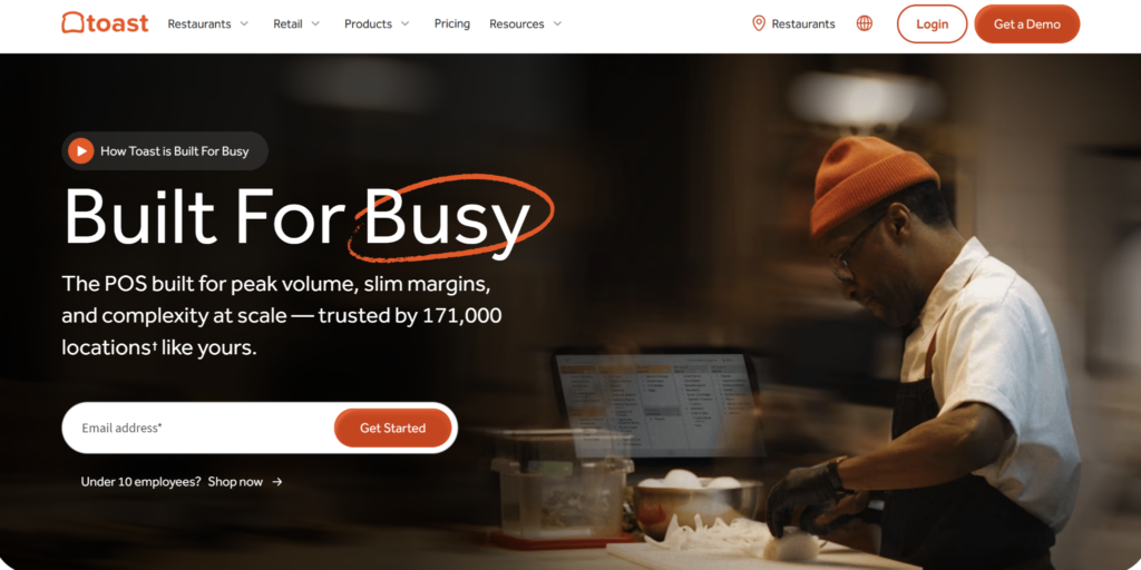 Toast homepage promoting restaurant POS software with a chef preparing food in a commercial kitchen and messaging about high-volume restaurant operations.